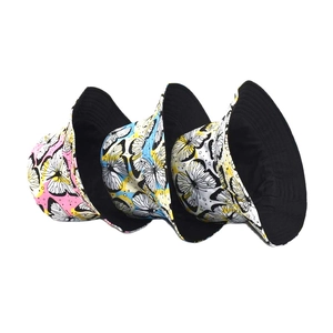 Three reversible butterfly pattern bucket hats in pink, blue, and yellow for sun protection