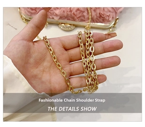 Detailed view of glossy gold metal chain strap on an elegant evening flower handbag