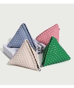 Macro view of woven leather texture and silver zipper on a mini triangular pouch