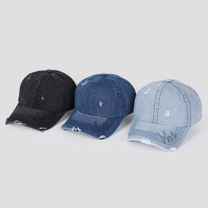 Three distressed washed denim baseball caps with ripped details in black and blue tones