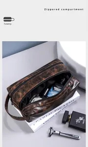 Detail of dark brown leather toiletry bag showing large capacity and zipper compartment