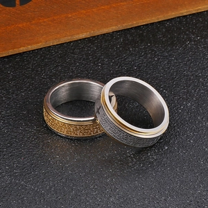 Detailed macro view of rotating stainless steel spinner rings with cross and scripture