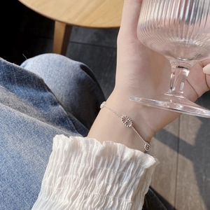 Detailed close-up of a silver S925 sterling silver chain bracelet with CD link charm