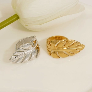 Minimalist stainless steel leaf open rings in gold and silver finish on elegant floral background