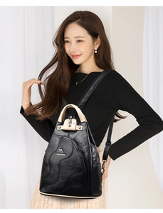 Detail of multi-functional PU leather backpack with contrast trim and metal logo