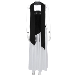 Detail of elegant black halter neck top with white maxi skirt and neck scarf ensemble