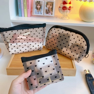 Three-piece black mesh makeup bag set with heart pattern showing different pouch sizes