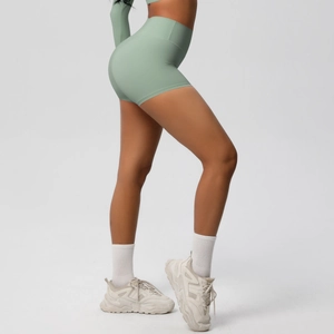 Side view of high-waisted sage green yoga shorts with scrunch butt and tummy control effect