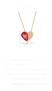 Macro detail of S925 silver heart necklace with red pear-cut stone and white zircons