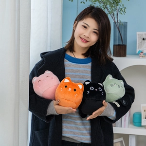 Cute plush cat dolls in pink orange black and green colors held by a model in a cozy room