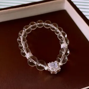 Elegant crystal beaded bracelet with zircon pendant on premium brown leather display
