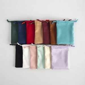 Multi-color drawstring flannel jewelry pouches displayed in two neat rows on white background