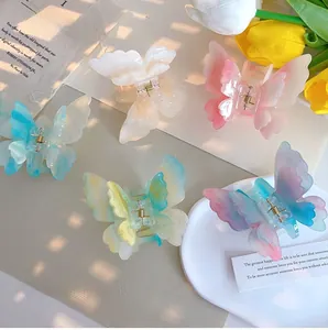 Detailed set of colorful butterfly hair clips with iridescent finish and gold spring clasp