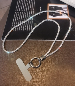 Detailed view of luxury rhinestone phone lanyard with silver swivel hook and grey patch
