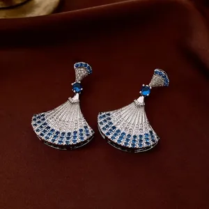 Elegant silver fan-shaped drop earrings with blue and white zircon stones on brown silk