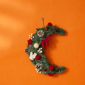 Christmas crescent moon wreath with pine needles, cones, red horse ornament and lights