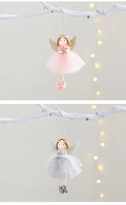 Detail of pink and grey angel ornaments with mesh wings hanging on white branches