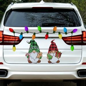 Close-up of festive Christmas gnomes and colorful bulb stickers on a white SUV rear window