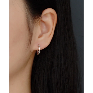 Close-up of geometric S925 silver hoop earrings with clear diamonds on ear