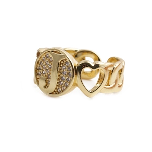 Detail of gold letter J ring with heart design and small sparkling zircon stones