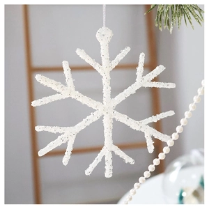 Close-up of a white glittery snowflake ornament hanging on a festive Christmas tree