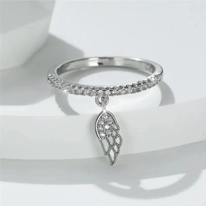 Exquisite silver feather wing ring with sparkling zircon pendant on white display