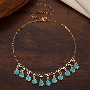 Detail of bohemian necklace with eleven turquoise teardrop pendants on wood
