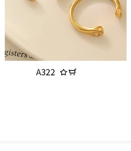 Detail of gold-plated metal open ring on a book with soft warm lighting and minimalist aesthetic