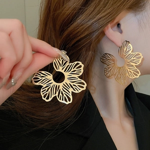 Minimalist golden hollow flower earrings with exaggerated designer petal shape for women