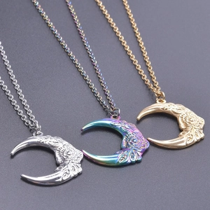 Detailed close-up of crescent moon pendants with floral patterns in silver, gold and rainbow
