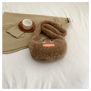 Detailed close-up of fluffy brown plush crossbody bag with cute eyes and sausage mouth