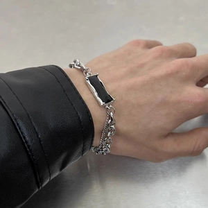 Detail of silver double-layer hip-hop bracelet with black rectangular stone on wrist