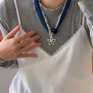 Handmade silver flower pendant necklace with blue denim fabric cord and black bead accent