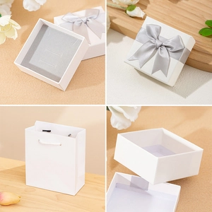Elegant white jewelry gift box set with silver-grey bow and matching paper carry bag