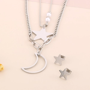 Detail of silver multilayer necklace with star moon pendants and pearl earrings set