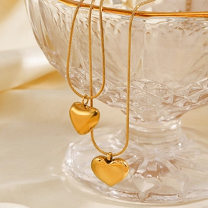 18K gold plated stainless steel heart pendant necklace on an elegant satin background