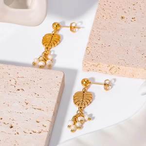 18K gold plated stainless steel leaf earrings with natural pearls on white background