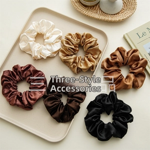Detail view of 6-pack satin scrunchies set in earth tones with silk texture and soft shine