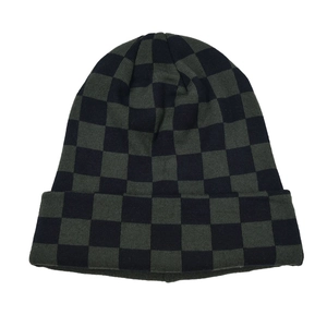 Detail of dark green and black checkered knit beanie with a folded cuff texture