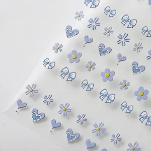 3D embossed light blue nail art stickers with daisy and bow designs on white background