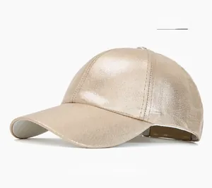 Detailed close-up of cream snakeskin baseball cap showing glossy metallic PU leather texture
