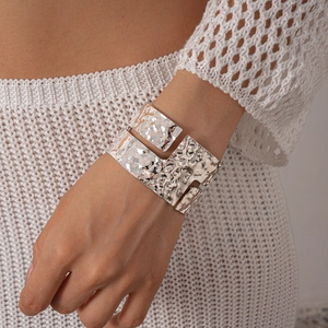 Detailed view of wide hammered silver cuff bracelet with layered geometric hollow design