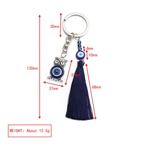 Detail showing blue evil eye owl keychain dimensions 130mm with dark blue tassel charm