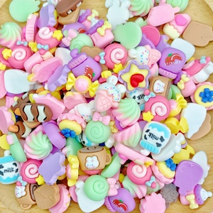 Close-up of colorful resin candy stars and milk bottle charms for DIY nail art and hair accessories
