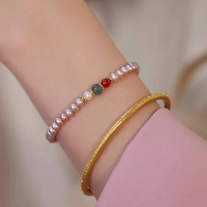 Wrist view of pink freshwater pearl bracelet with natural agate beads and gold bangle