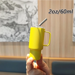 Detailed close-up of a 2oz 60ml yellow mini stainless steel tumbler with handle and straw