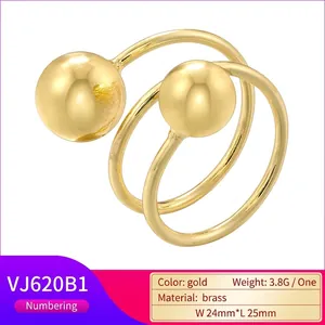 Adjustable golden brass ring with hammer texture and double spheres in minimalist style