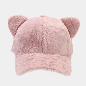 Detailed texture of pink plush baseball cap featuring cute cat ears on a clean background
