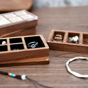 Close-up of black walnut jewelry box with soft black velvet lining and dividers