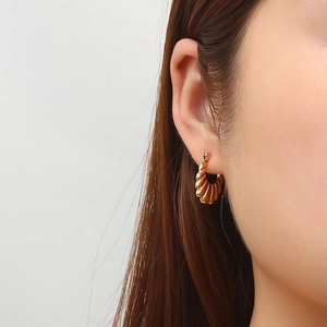 French retro 18K gold plated stainless steel twisted hoop earrings on female model